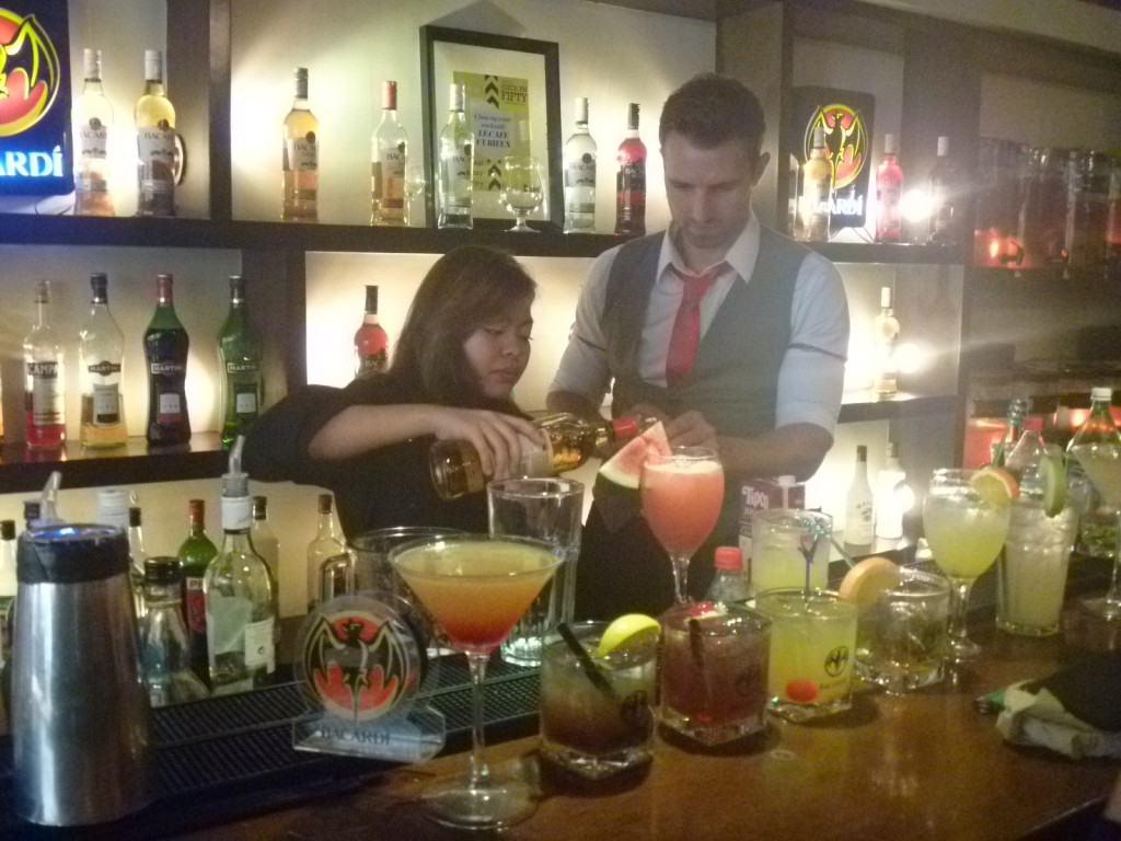 Anthony assisting a participant preparing a cocktail